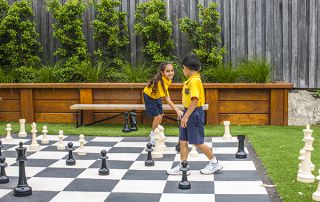 students playing chess at multipurpose courts